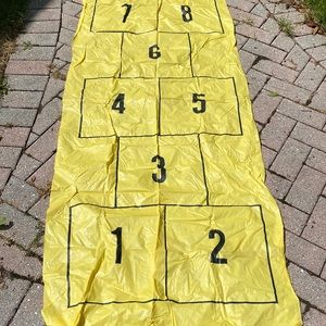 Vintage yellow plastic hopscotch mat.